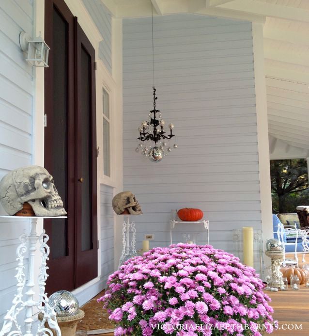 Decorating our Victorian porch for Halloween… I used mason jars with tea lights and made a DISCO chandelier.