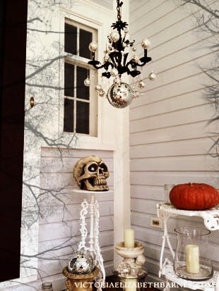 Decorating our old-house’s front porch for Halloween… I lined the walkway with mason jars and tea lights, and made a DIY Halloween chandelier