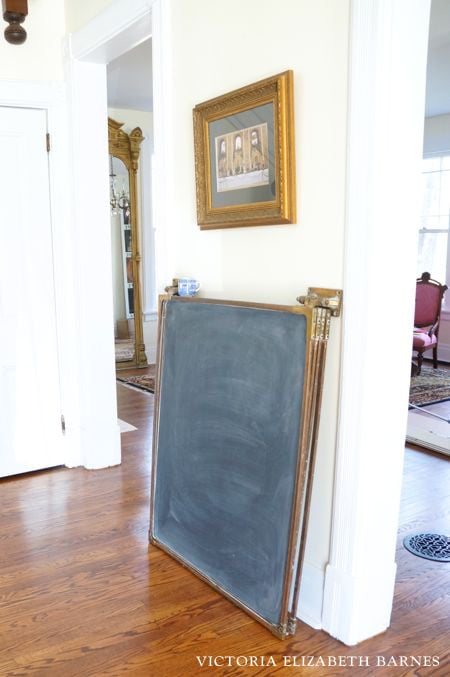 We are DIY-ing a falling-down Victorian house, one room at a time… and the BEST part is the decorating! This antique, brass hinged chalkboard is one of my favorite salvaged finds!!