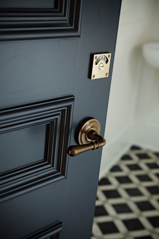 Brass hardware stands out against a dark door… the “occupied” lock on the bathroom door is pretty AND practical. 
