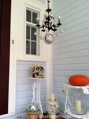 Decorating our old-house’s front porch for Halloween… I lined the walkway with mason jars and tea lights, and made a DIY Halloween chandelier