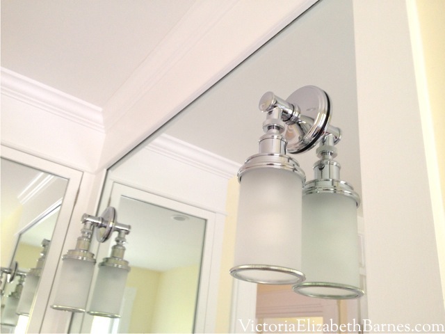 Installing sconces through a large mirror, clean bright bath design, mirror to ceiling in bath