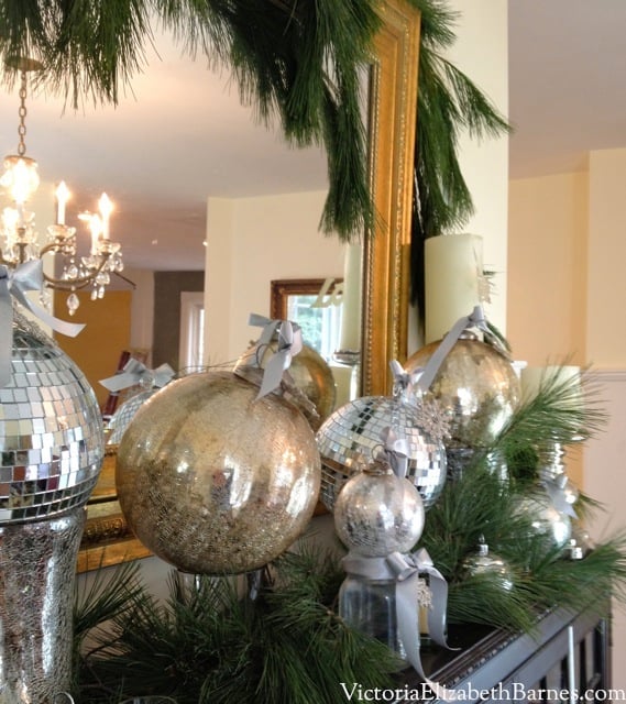 How to make a bow for Christmas decorating. How to make your dining room look elegant. Decorating with evergreen garland and mercury glass Christmas ornaments. Fast, easy Christmas decorations using household items. Adding bows to holiday ornaments