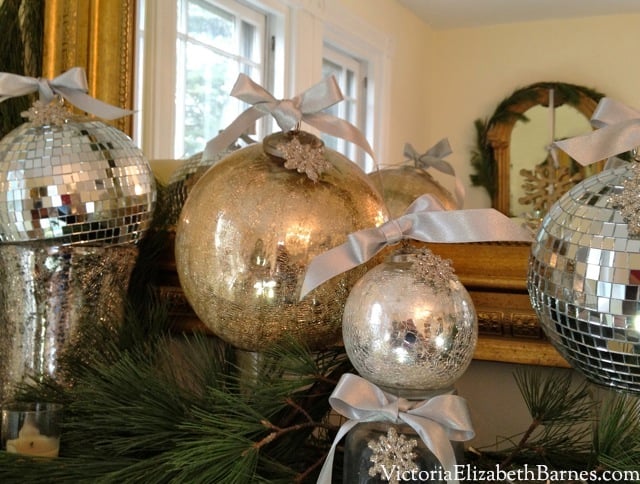 Elegant holiday table setting. Sparkly glamorous decorations. How to make a bow. How to make elegant dining room decorations. Decorating with evergreen garland and mercury glass Christmas ornaments. Fast, easy Christmas decorations using household items. Adding bows to holiday ornaments