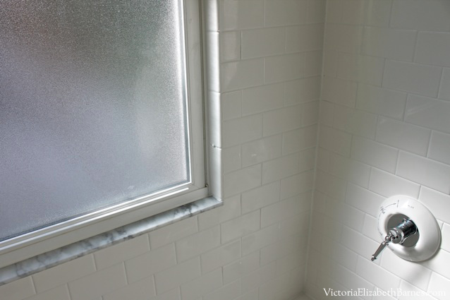 Our old-house bathroom has a large window IN the shower... See our DIY solution to cover it... and the entire before-and-after remodel!