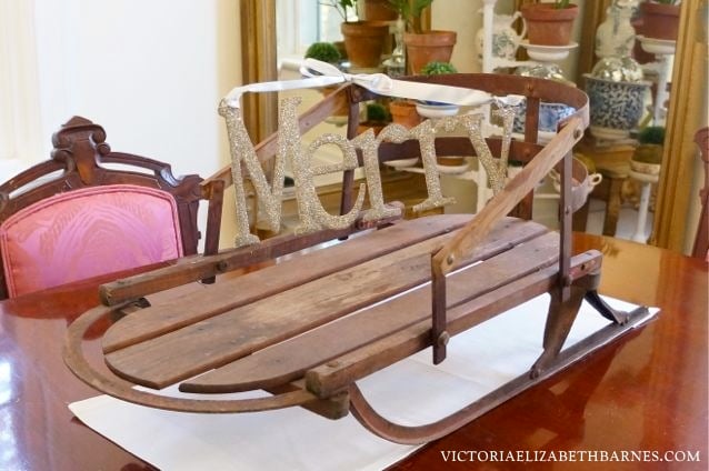 Decorating our old Victorian house for Christmas… I love repurposing antiques like this baby sled.