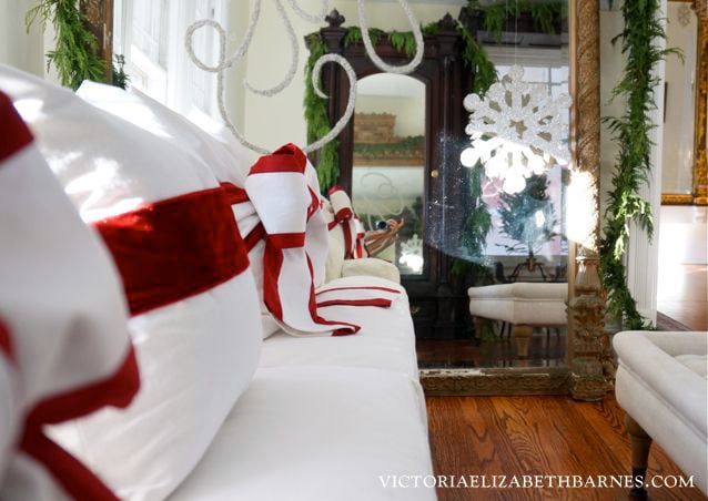 A simple bow turns your sofa pillows into Christmas decorations!! I LOVE the two-tone bow!!