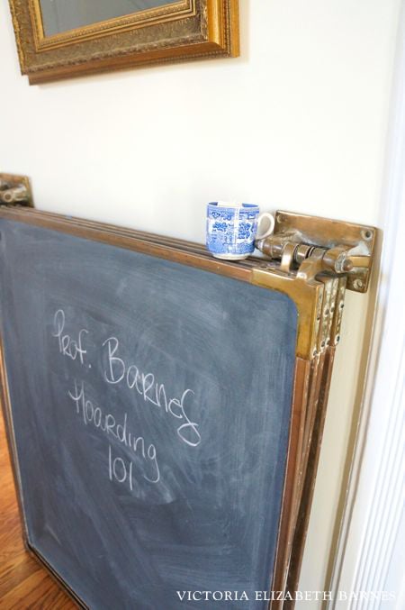 We are DIY-ing a falling-down Victorian house, one room at a time… and the BEST part is the decorating! This antique, brass hinged chalkboard is one of my favorite salvaged finds!!