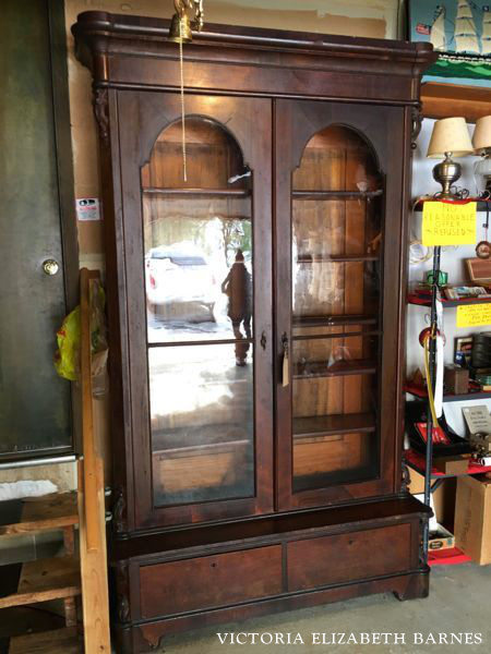 Using salvaged and repurposed materials for the kitchen remodel in our old Victorian house! This antique glass front bookcase is going to double as cabinetry and a pantry! See the entire kitchen project… we are repurposing some really beautiful furniture!